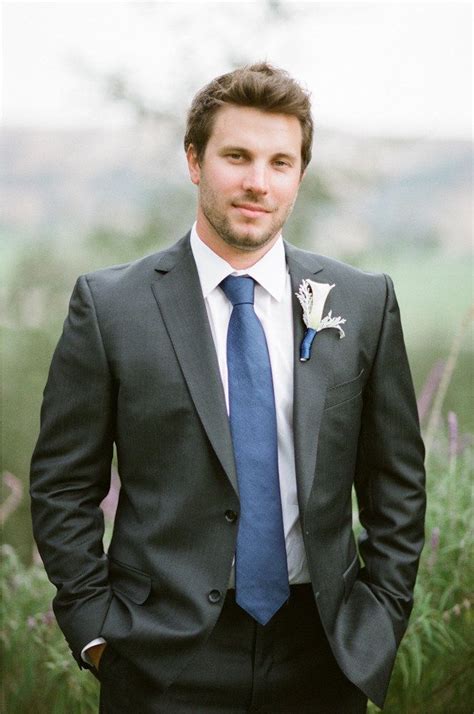 charcoal suit with blue tie.